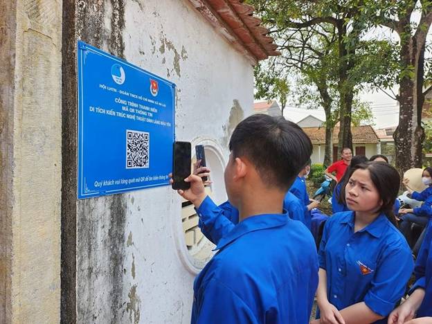 A group of people in blue uniforms taking a picture of a sign

Description automatically generated